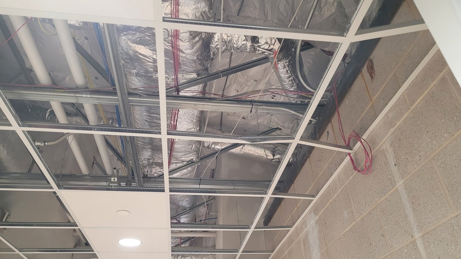 Installation of acoustic ceiling tiles in an office environment