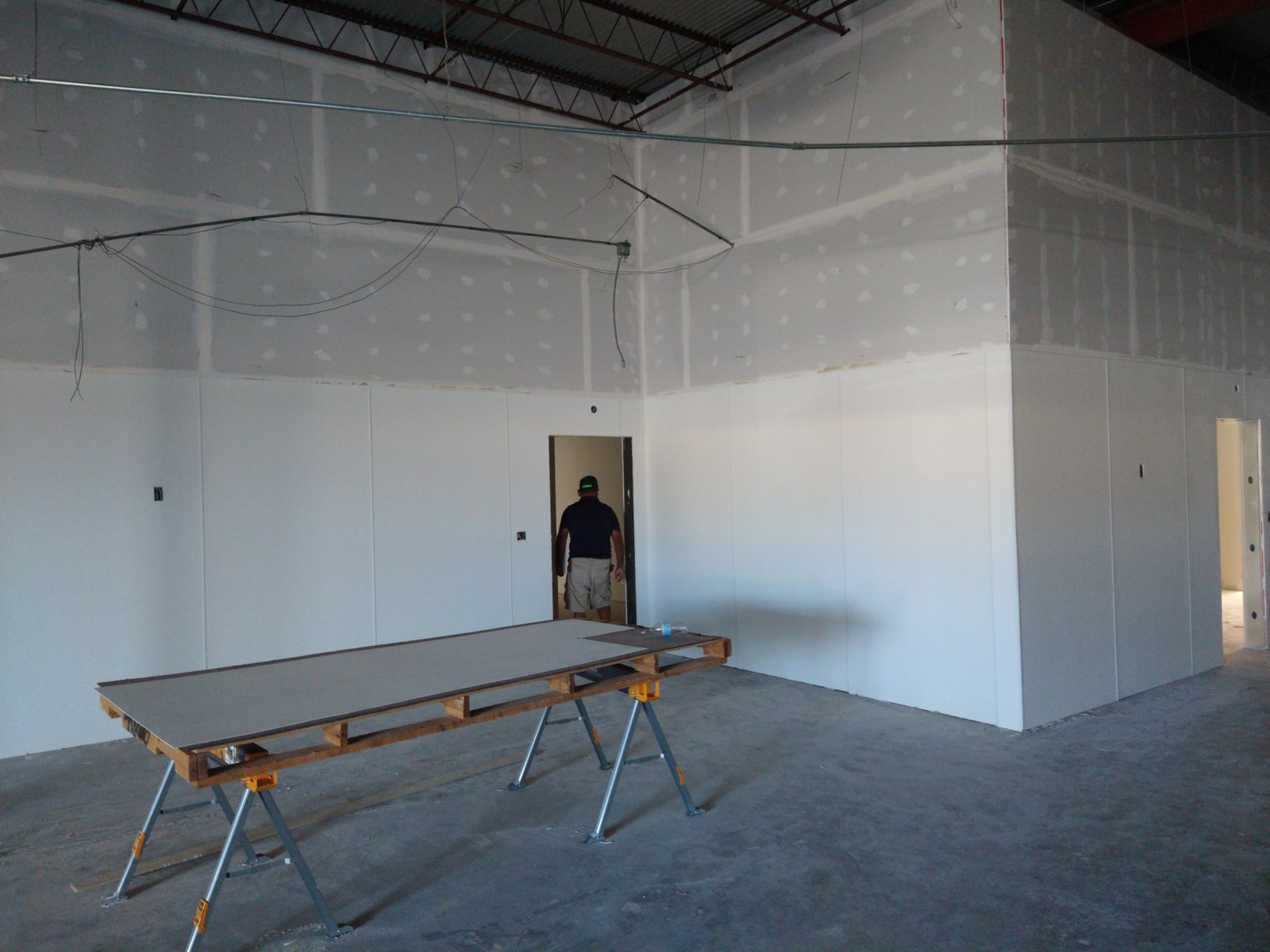 Sheetrock panels being installed on interior walls